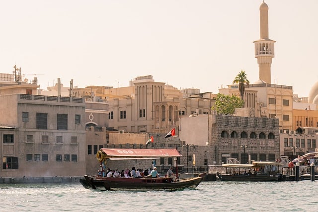 Boat with people on a calm lake near a beautiful residence and green surroundings.
