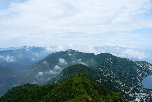 Scenic view of Nainital's lush green hills, floating clouds, and misty fog—perfect for your Nainital Tour Packages adventure