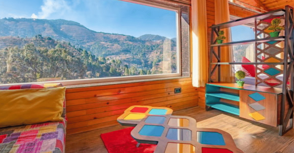 A cozy wooden homestay cottage with a balcony overlooking lush green hills and pine trees near Nainital, perfect for a peaceful mountain stay.